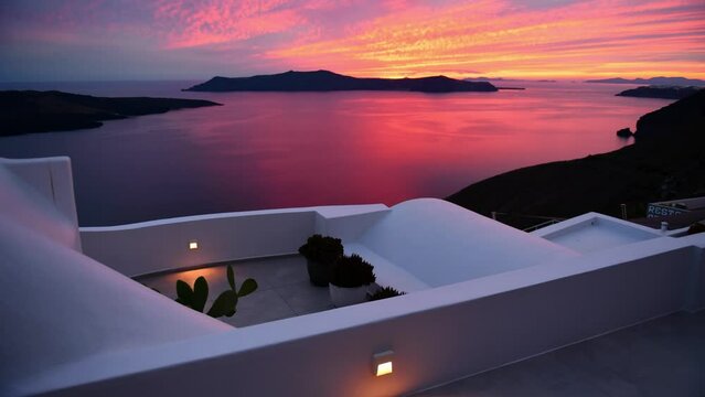 Pink sunset at Santorini island, Greece. Timelapse. White architecture with sea view in Fira town. Summer travel and vacation
