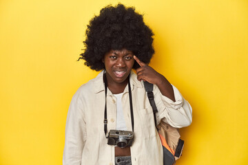 Stylish African-American woman with vintage camera Stylish African-American woman with vintage camera.showing a disappointment gesture with forefinger.