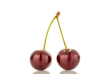 Two ripe cherries, macro, isolated on a white background.