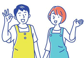 笑顔で案内するエプロン姿の若い2人の男女セット