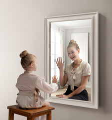 Creative conceptual collage. Little girl looking in mirror and seeing reflection of young girl. Greeting her future self. Concept of present, past and future, age, lifestyle, generation, ad - obrazy, fototapety, plakaty