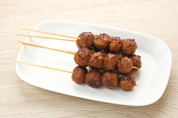 Grilled meatballs skewers with teriyaki sauce
