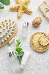 Fototapeta na wymiar Cosmetic, massage and bath accessories set on white texture background
