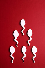 Sperm cells on red background.