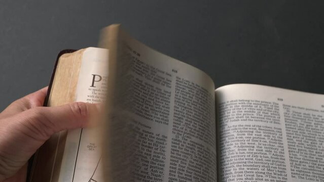 Turning bible pages, from the book of Prophets, Daniel. Close up view.