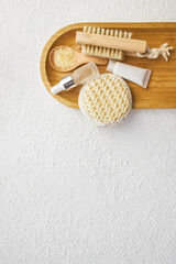 Fototapeta na wymiar Spa and bathroom accessories on wooden tray, brush, oil, cream