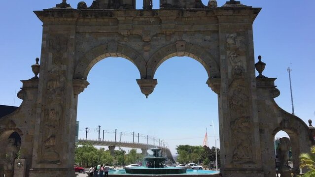 Arcos de Zapopan limestone monument with tourist, Guadalajara, Mexico