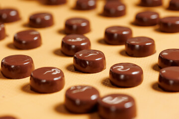 Chocolate production factory. Sweets candy on conveyor. Process cocoa glazing. Concept food industry