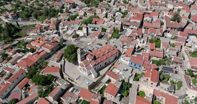 Aerial view of Lefkara Cyprus cityscape. In the central part of the city is an old church with a bell tower. Beautiful architecture of old European cities. High quality 4k footage