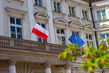 Polish national flag and flag of European Union on the building Jablonowski Palace in Warsaw, Poland