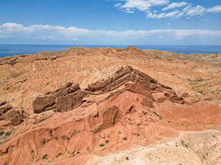 Fototapeta premium Top view, bird's eye view, Skazkak valley in Kyrgyzstan, chalk mountains with dried up river and grass