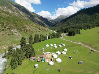 
Jety-Oguz gorge in Kyrgyzstan, yurts and domestic animals are visible, horses are grazing, top view