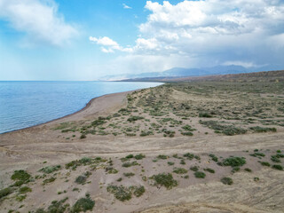 
View of sand castles, dunes and mountains from above, overlooking Issyk-Kul lake Ak-Sai gorge in...