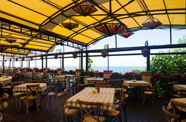 Beautiful cafe with flowers in Bulgaria. Outdoor restaurant, summer holidays