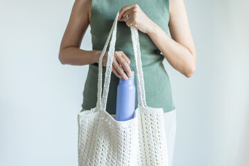 Hands woman take reusable water bottle from shopping bag,Healthy green,Zero waste,Environmental friendly