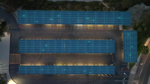 Aerial view above solar panels powering lights and cars at a Carport EV station