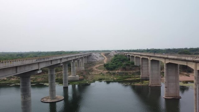 Highway bridge built over the river basin in the Indian rural terrain, Aerial view