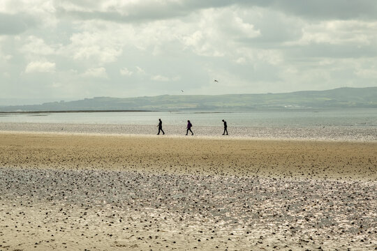 People walking on the beach in Troon, Scotland