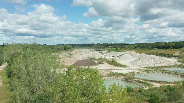 Daylight Aerial Flyover of Wide Shot Limestone Quarry in Operation