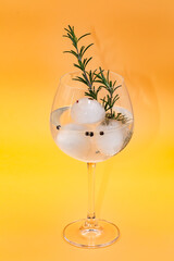Gin and tonic as classic long drink isolated on yellow background, studio shot