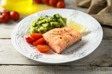 Healthy baked salmon fillet with mashed avocado