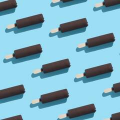 trendy seamless pattern of chocolate popsicle with ice cream and hard shadow on blue background, creative decoration of summer concept
