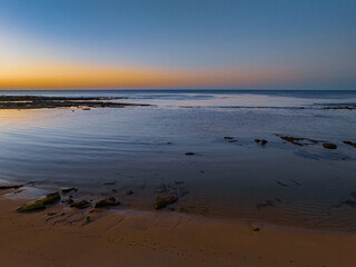 Sunrise with clear skies and calm seas