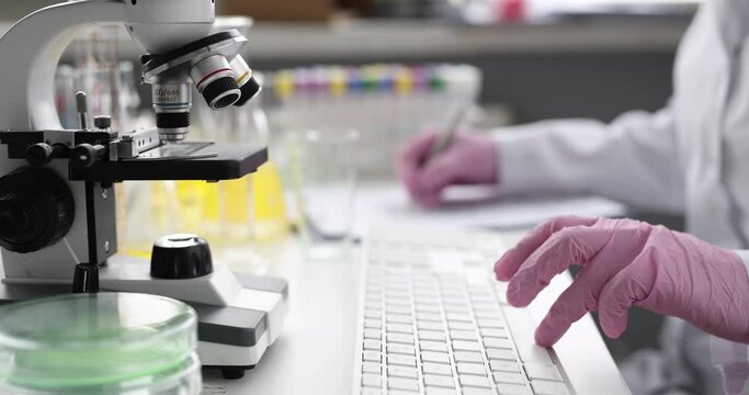 Doctor laboratory diagnostics recording result of analysis in computer database closeup 4k movie. Modern scientific technologies concept
