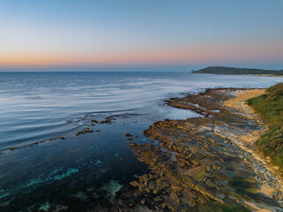 Sunrise with clear skies and calm seas