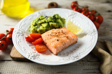 Healthy baked salmon fillet with mashed avocado