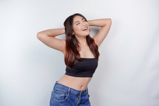 Portrait of happy young Asian woman wearing crop top isolated over white background. Diet concept.