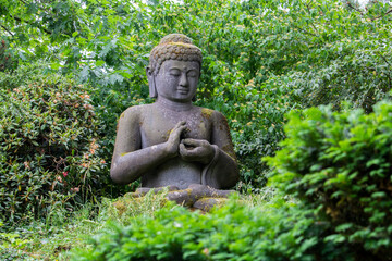 Buddha statue in Walsrode Bird Park among greenery. High quality photo
