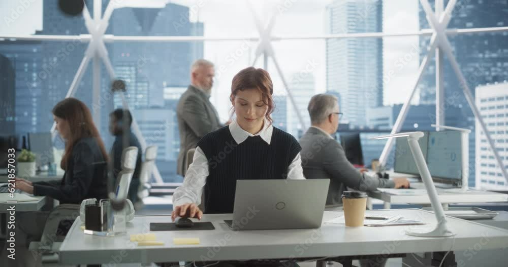 Aufkleber beautiful caucasian woman working on laptop computer in bright office in urban skyscraper office in 