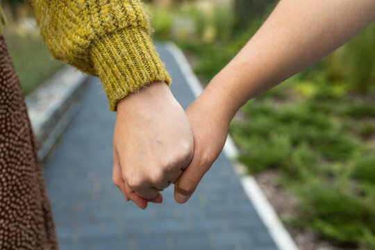 Cropped shot of young asian women LGBT lesbian couple holding hands with LGBT pride. High quality photo