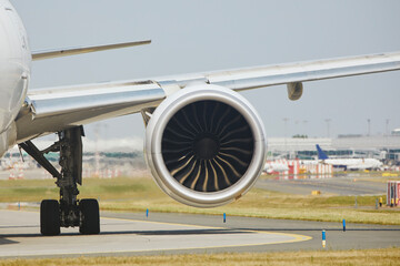Hot air behind jet engine of plane at airport. Airplane is taxiing to runway for take off during...