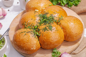 Obraz na płótnie Canvas Aromatic garlic buns. Fresh baked goods, a traditional gluten-free soup snack. Parsley, spices