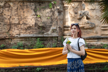 Pretty Asian tourists woman wearing beautiful hand-woven clothes dyed with indigo and mud-fermented...