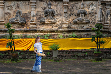 Pretty Asian tourists woman wearing beautiful hand-woven clothes dyed with indigo and mud-fermented...
