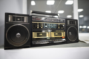 an old cassette recorder, a music center with a radio receiver - obrazy, fototapety, plakaty
