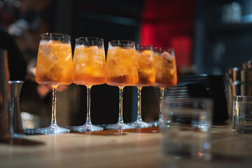 the bartender prepares a beautiful alcoholic cocktail at the bar counter