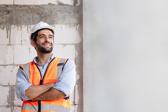  Engineer Handsome Man Or Architect Looking Construction With White Safety Helmet In Construction Site. Standing At House Site.