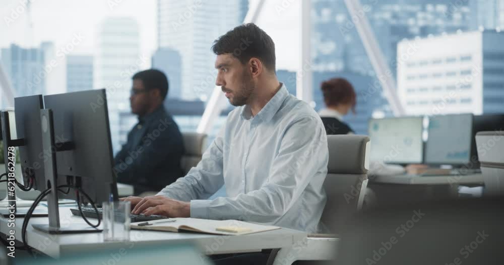 Poster Happy Male Account Manager Typing On Desktop Computer In Diverse Corporate Office With Megapolis Window View. Professional Caucasian Man Taking Notes and Creating Report For Consulting Company.