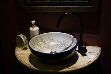 an ancient wash basin in a dark interior of a massage parlor