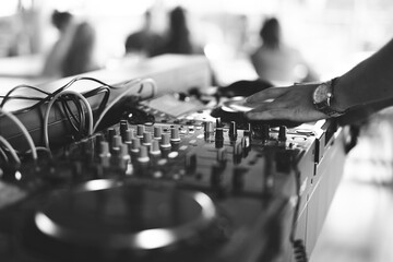 a DJ plays music on a controller at a party