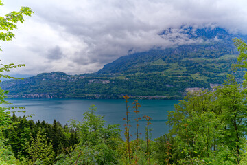 Fototapeta na wymiar Aerial view of scenic landscape with Lake Lucerne and Swiss mountain panorama in the background on a cloudy spring day. Photo taken May 18th, 2023, Seelisberg, Switzerland.