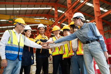 Group of diverse workers standing together in storehouse holding hands. Multicultural team working in logistic distribution warehouse Latino, Caucasian and Asian people in manufacturing industrial.