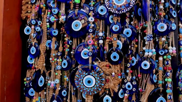 A lot of key rings and pendants, bracelets with a blue eye, amulets, beads from the evil eye in the souvenir shop of the Turkish city