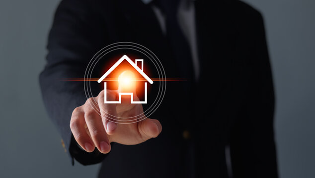 Business, technology, internet, and networking concepts: businessmen pressing the real estate button on virtual screens.