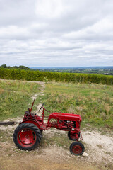 Fototapeta premium Red tractor near Monbazillac castle (Chateau de Monbazillac), Dordogne department, Aquitaine, France
