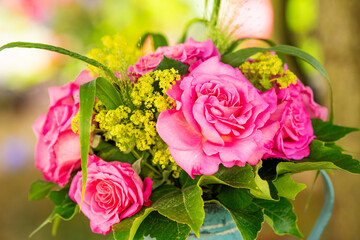 Roses flower bouquet in a old enamel jug